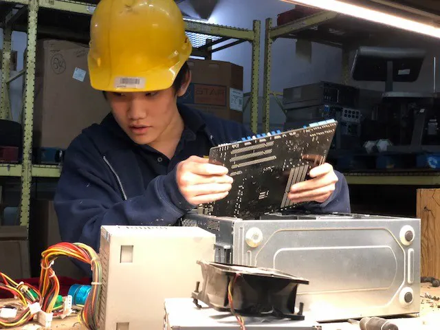 Student fixing computer